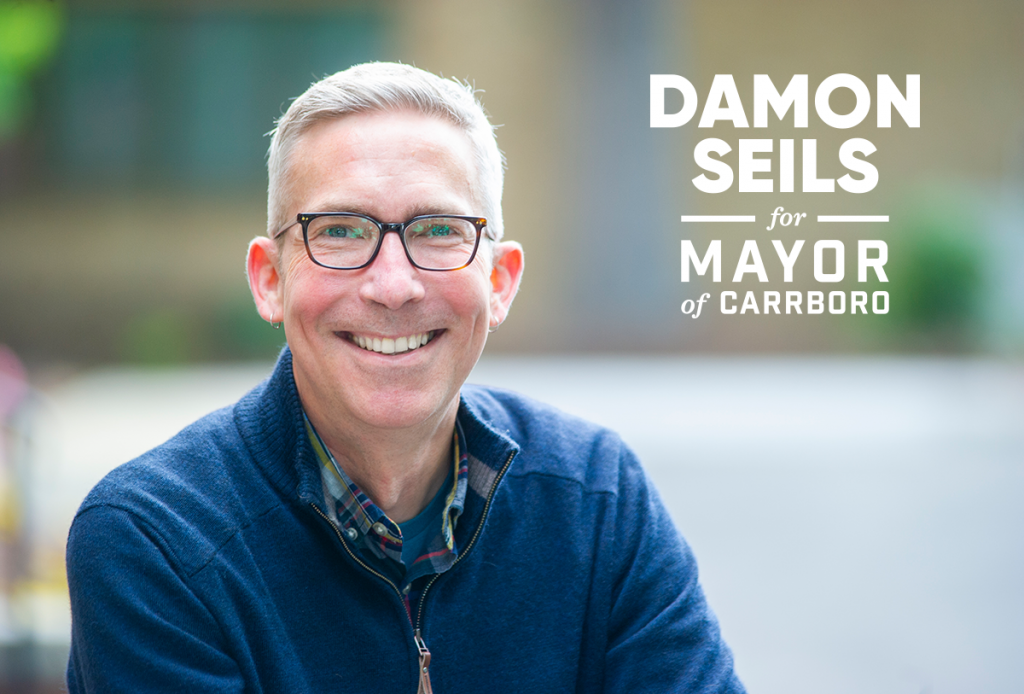 Headshot of Damon Seils with logo reading Damon Seils for Mayor of Carrboro